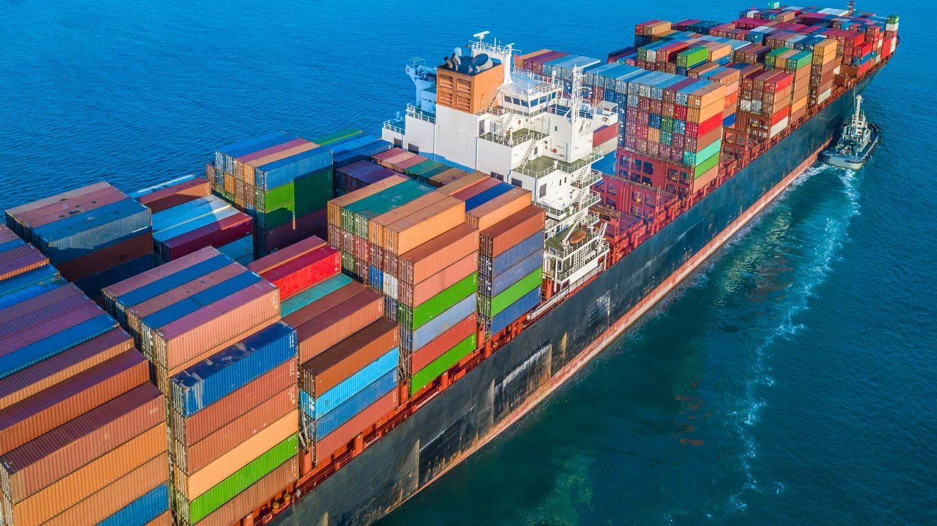 Container ship loaded with colorful shipping containers sailing to Bahrain